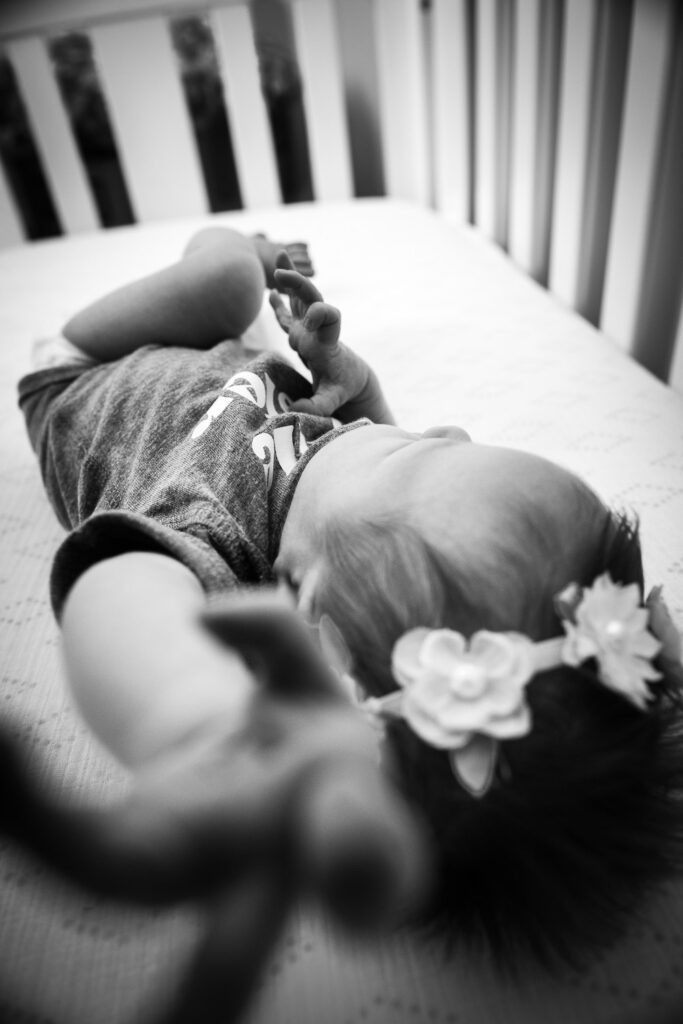 newborn reaching in crib