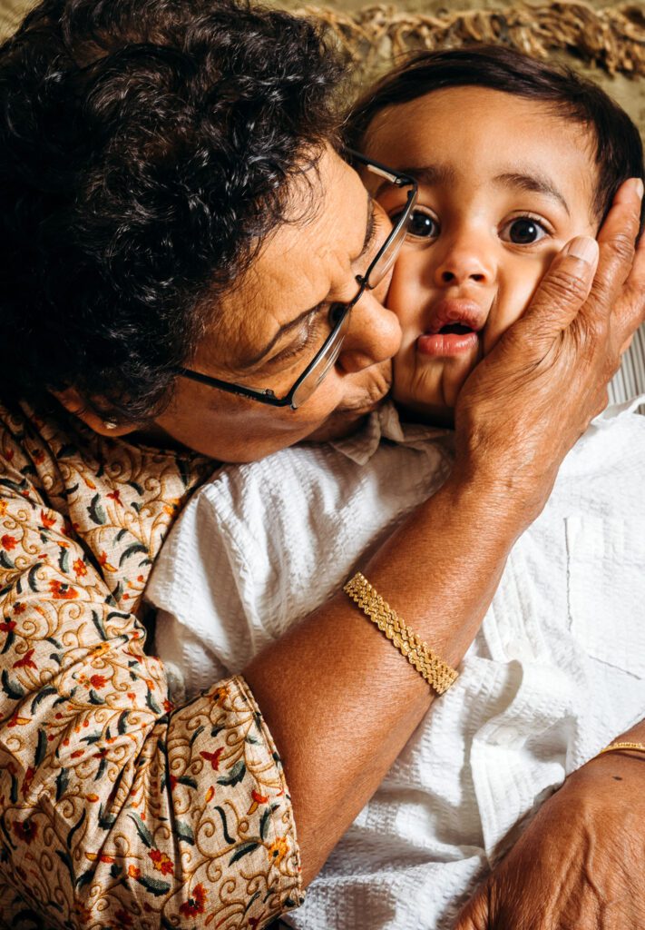 Grandma Kisses grandson and squishes cheeks