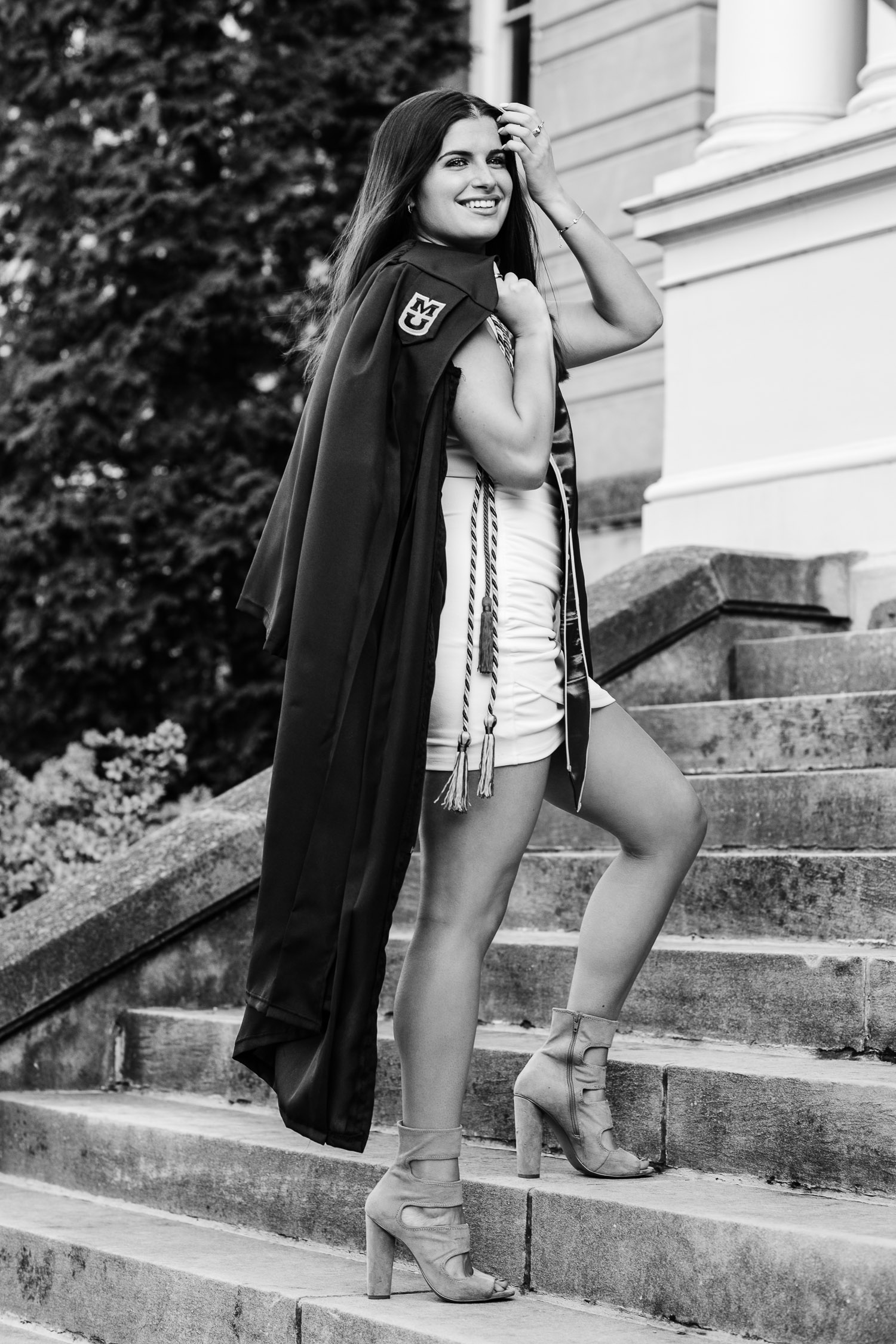 Mizzou senior girl holding graduation gown over shoulder
