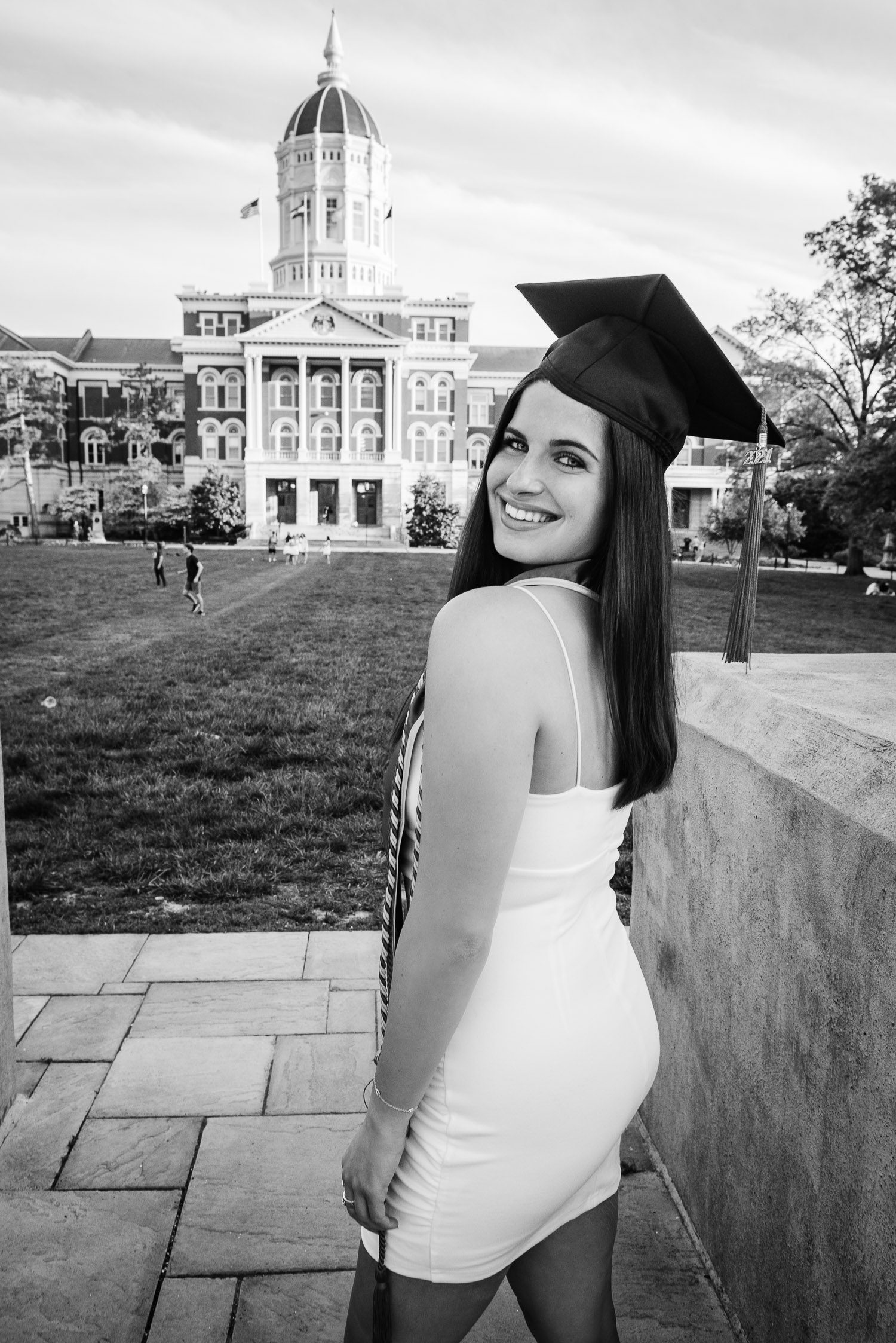 College Girl Graduating looking over shoulder