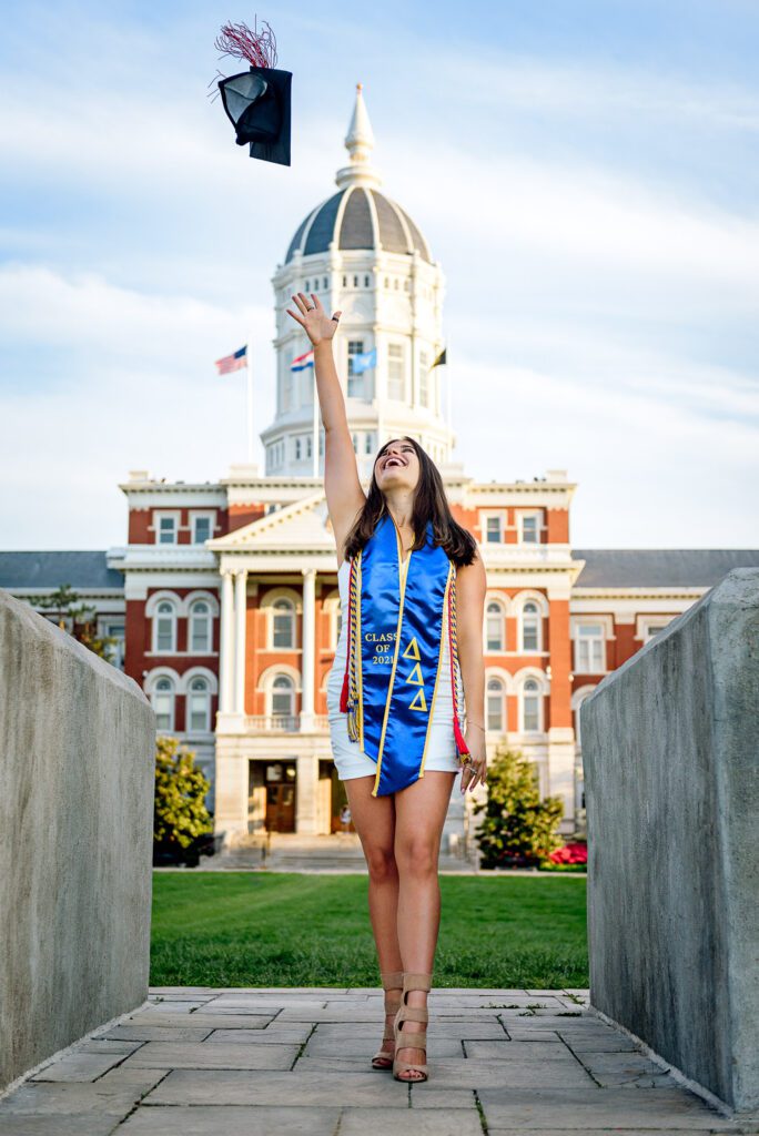 College Girl throwing Graduation Cap in air at Mizzou