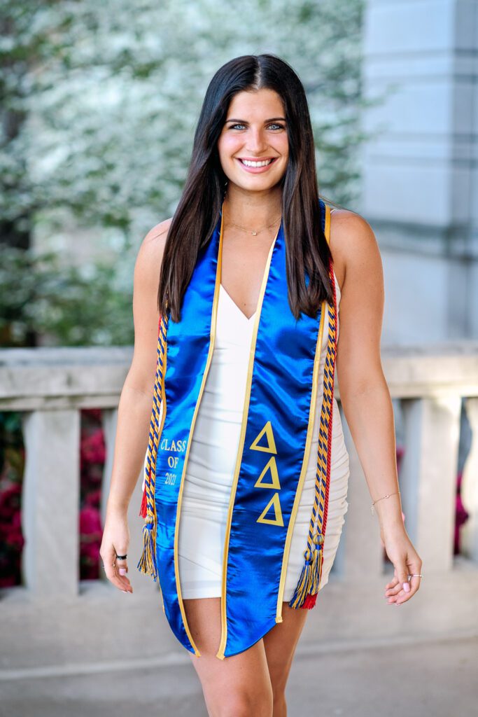 beautiful college graduate wearing white dress