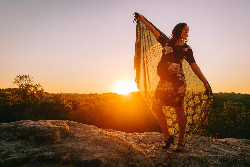 sunrise behind peacock fabric maternity pose