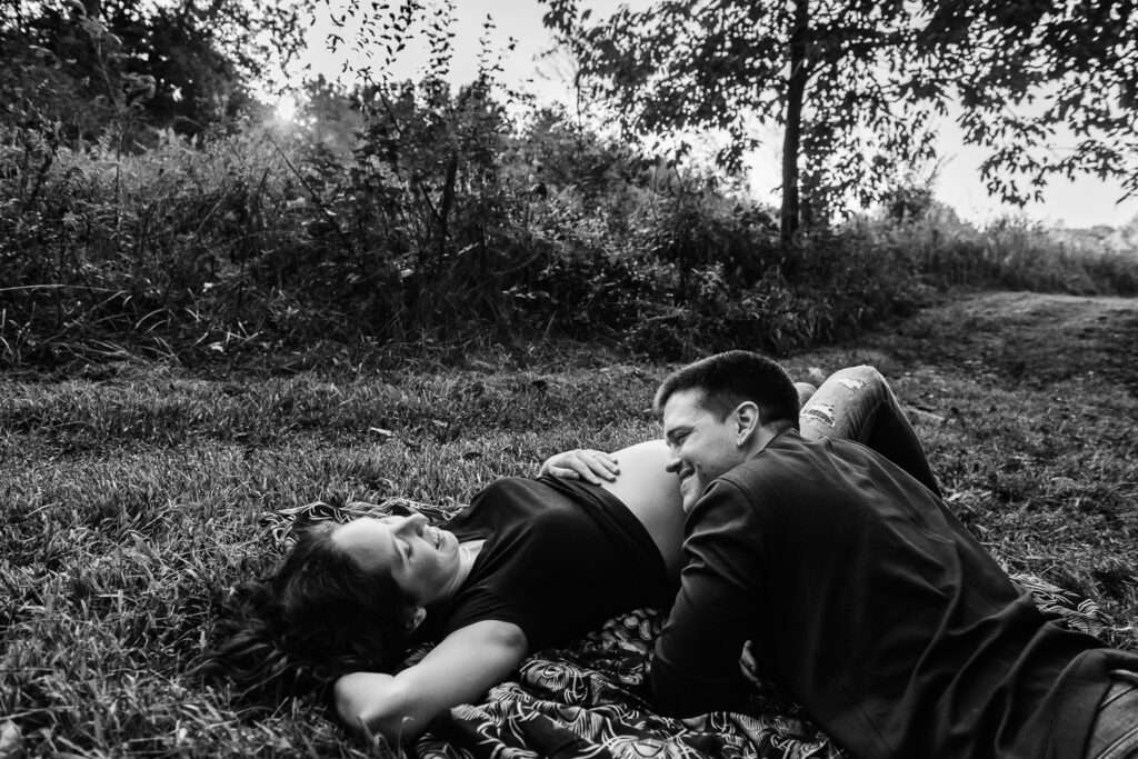 guy rests head on wife's pregnant belly