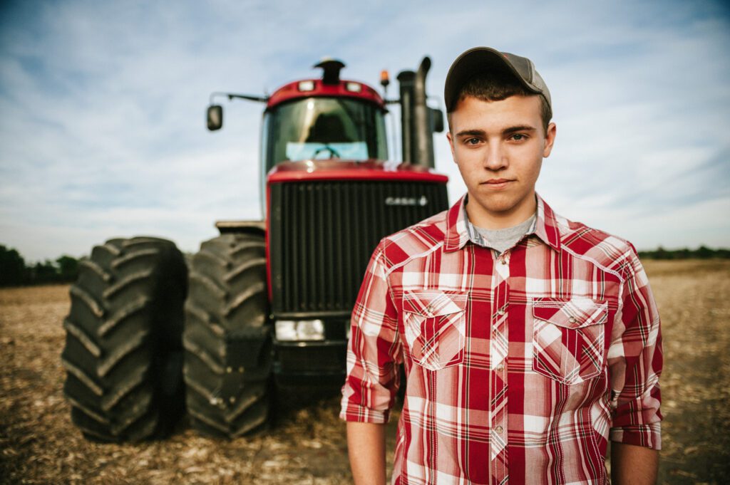 senior farmer in front of case tractor