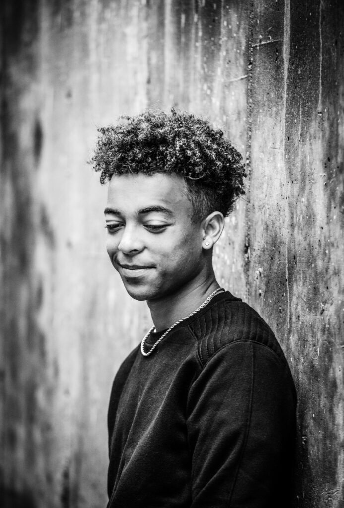 senior guy leaning on concrete wall