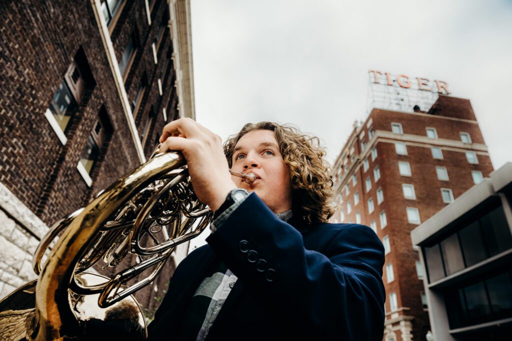 senior guy french horn near tiger hotel