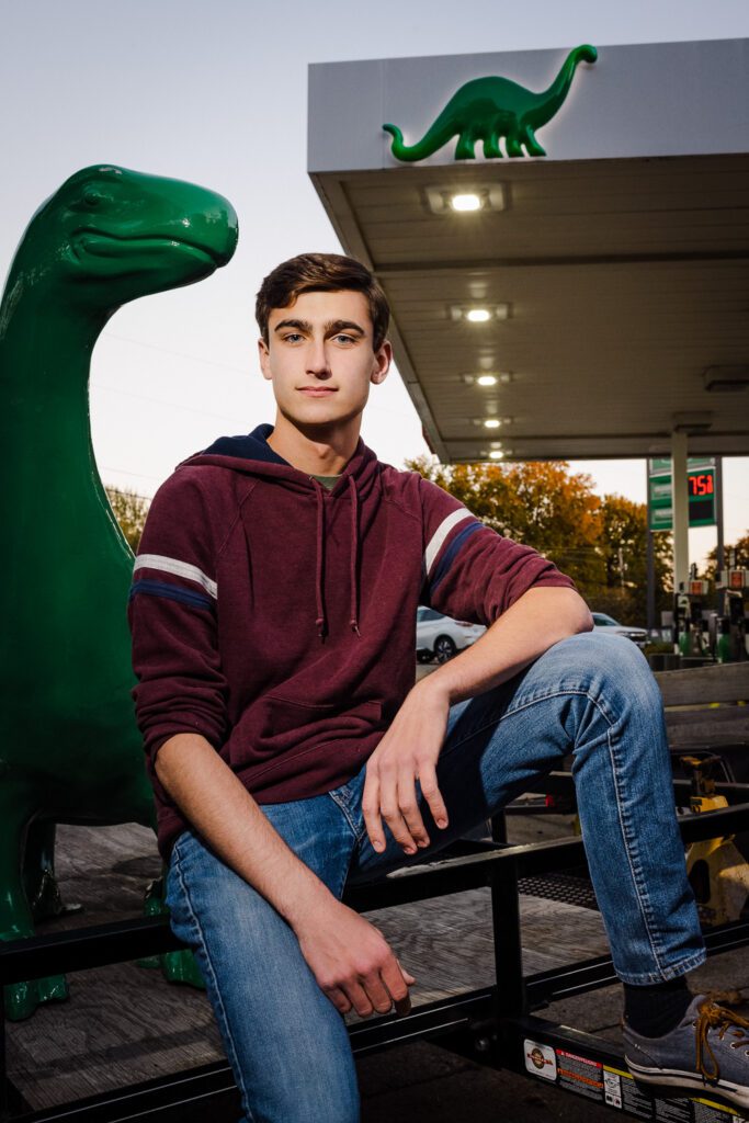 senior guy sinclair gas station dinosaur