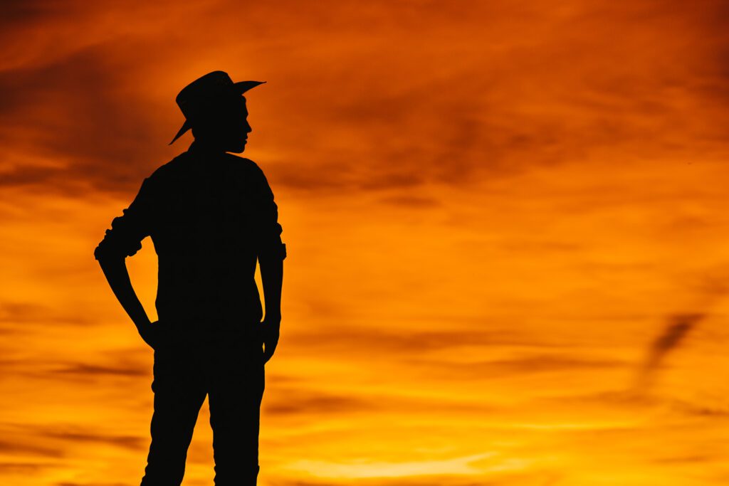 senior guy cowboy hat orange sky