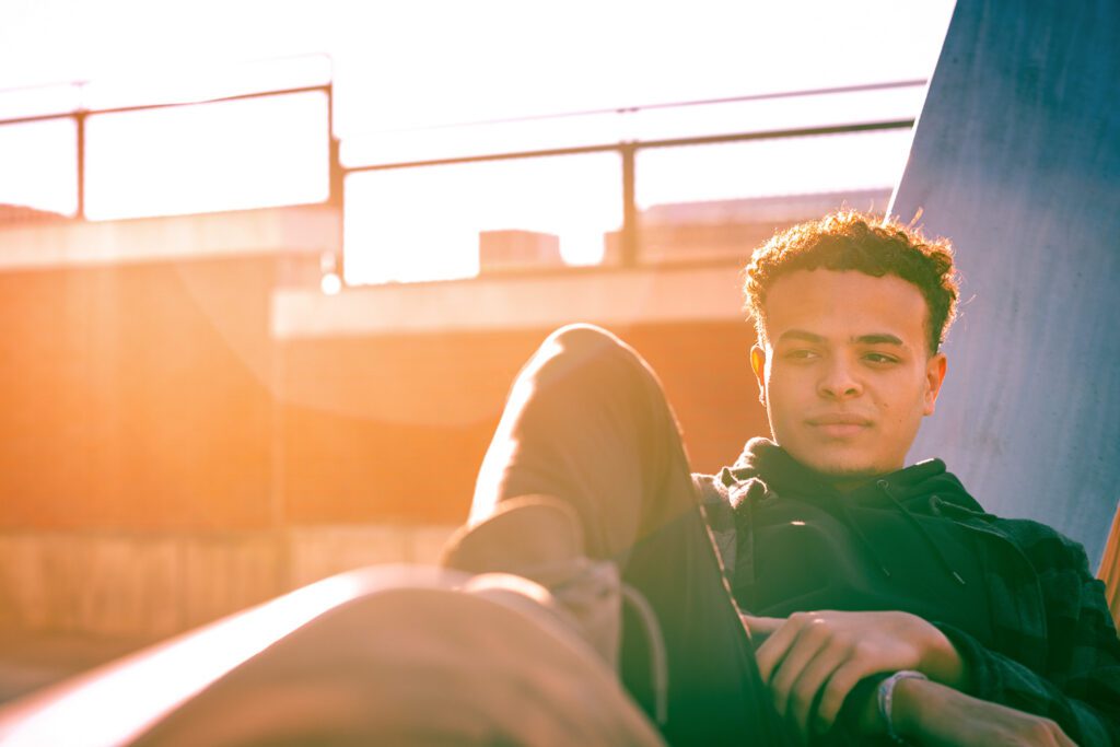 senior guy relaxing on statue