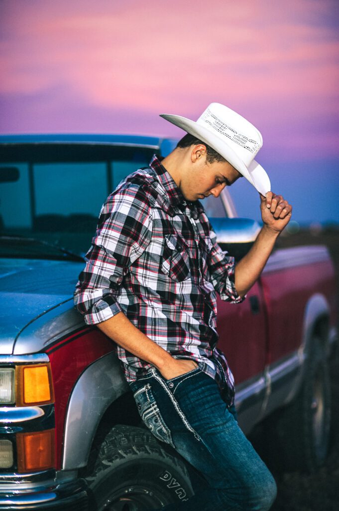 senior guy sunset tipping cowboy hat