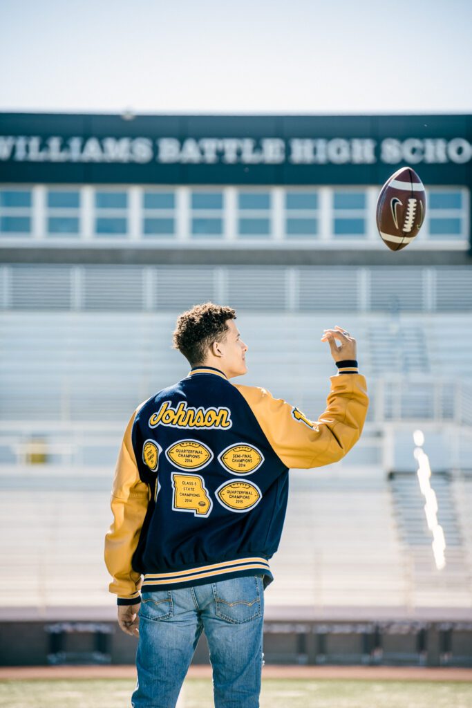 senior guy tossing football