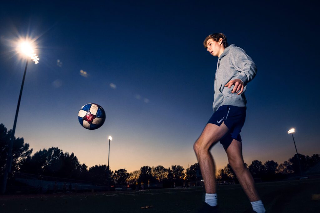 senior soccer player kicks ball