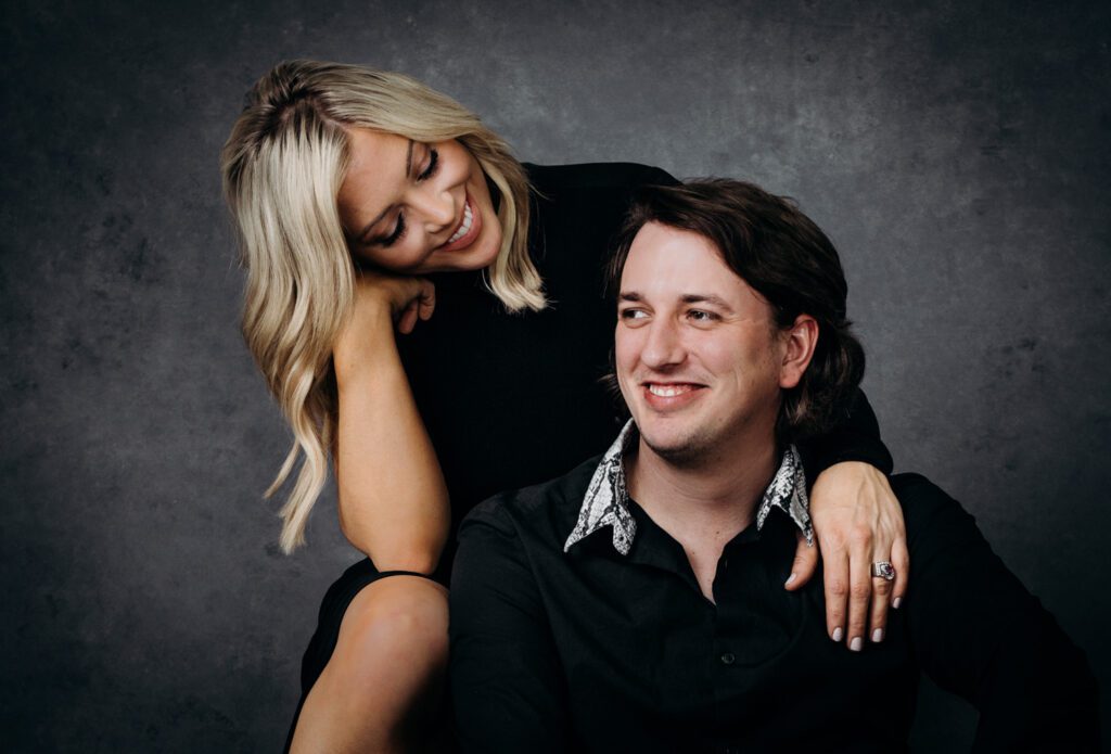 engagement couple smiling Oliphant backdrop
