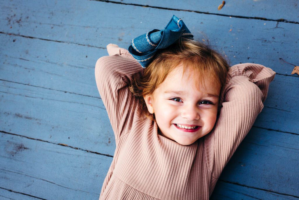 child laying blue porch at nifong park