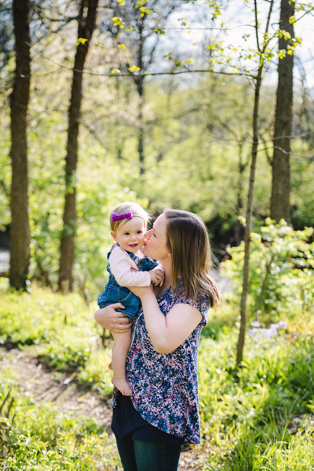 Mom kissing daughter on cheek Kasmann Family Photos by Schaefer Photography in Capen Park, Columbia, Missouri.