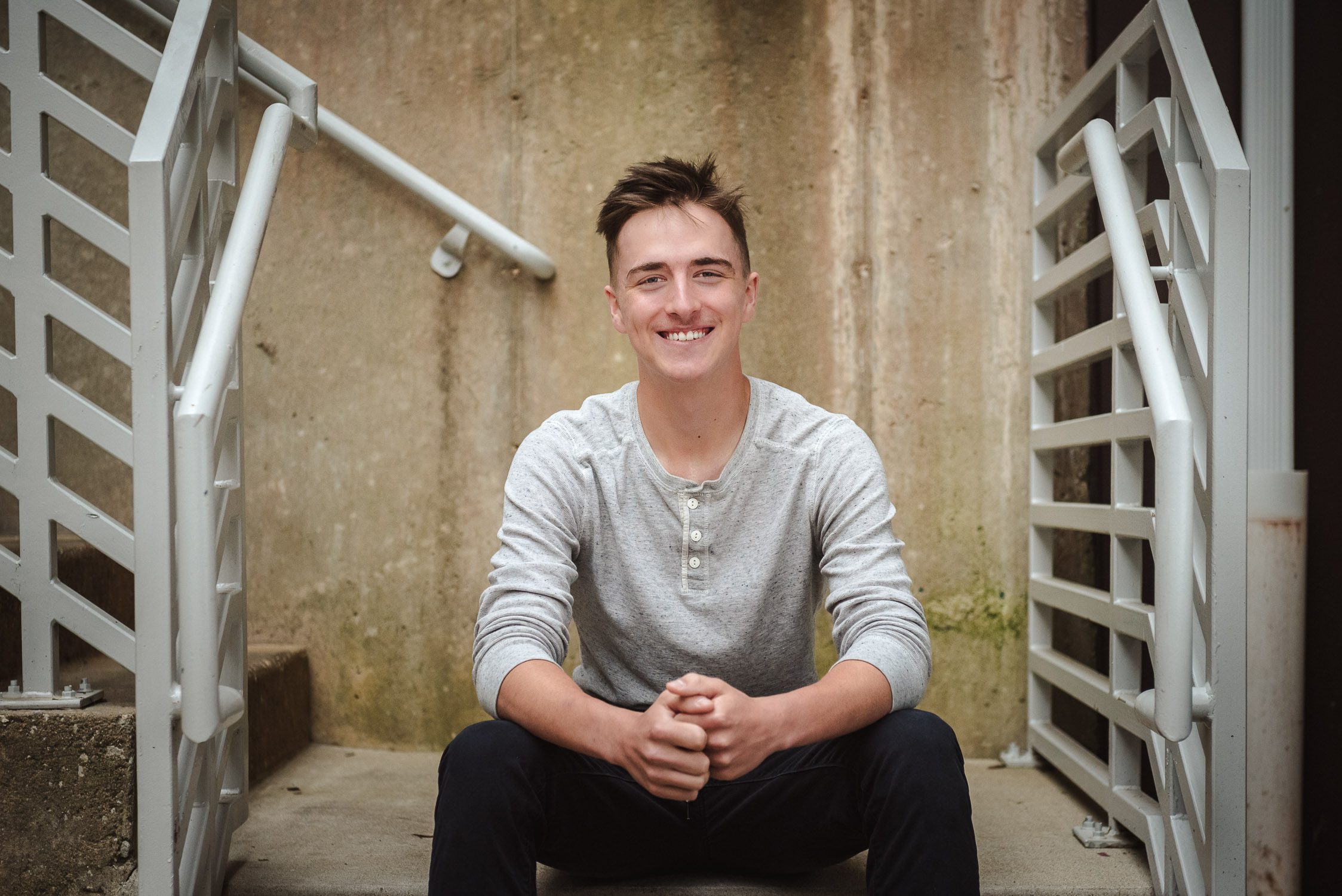 senior guy sitting in stairwell