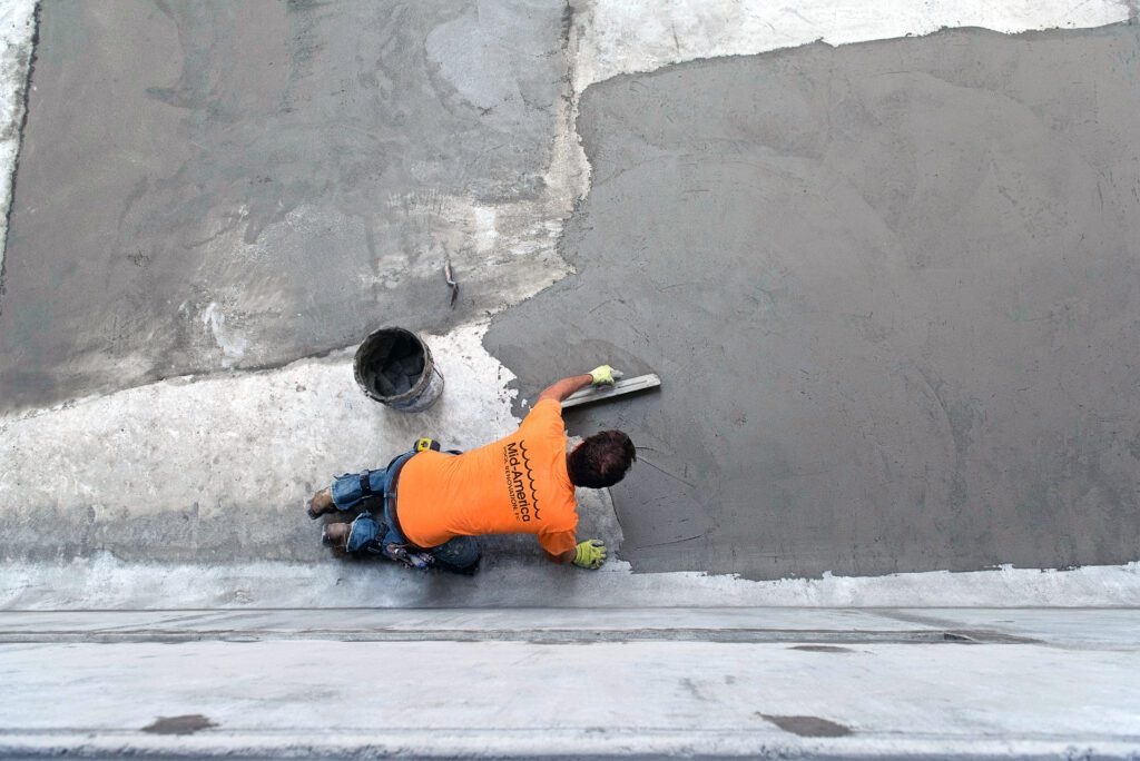 pool worker plastering new pool liner