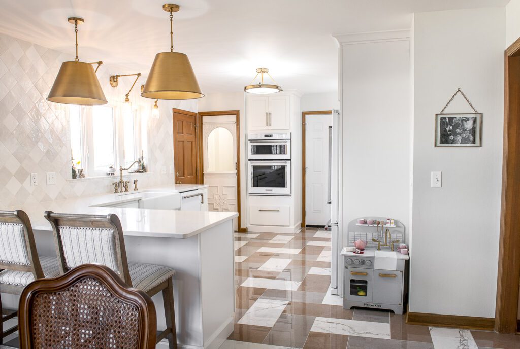 white kitchen with bronze lights