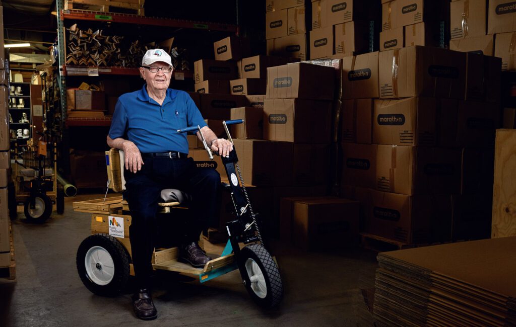 Mel West sits on a PET cart from Mobility Worldwide