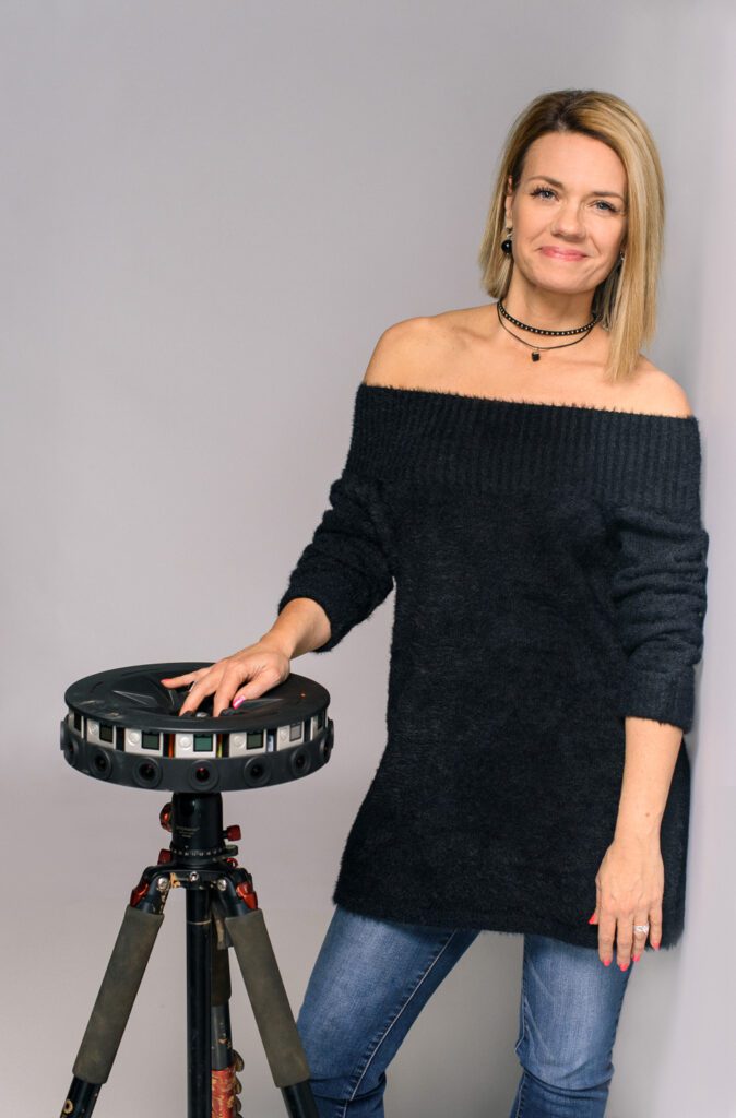 Sarah Hill standing with 360 degree camera