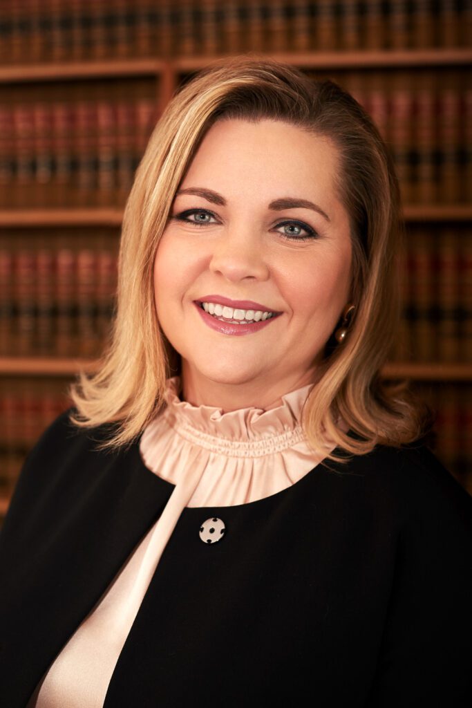 Female judge standing in law library.