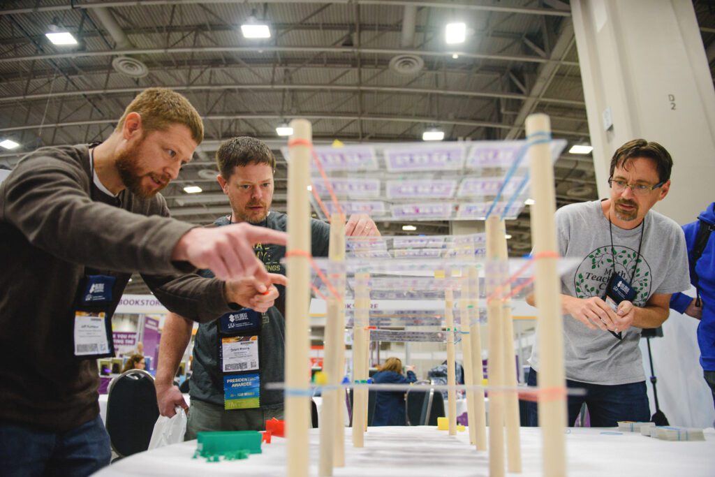 three guys working together using math skills to build structure
