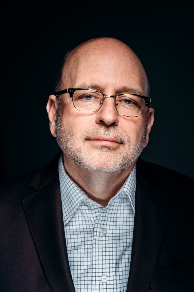 Stacey Woelfel headshot of black background