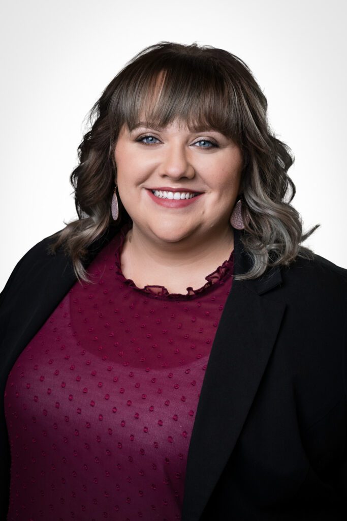 Female smiling for professional headshot in a suit