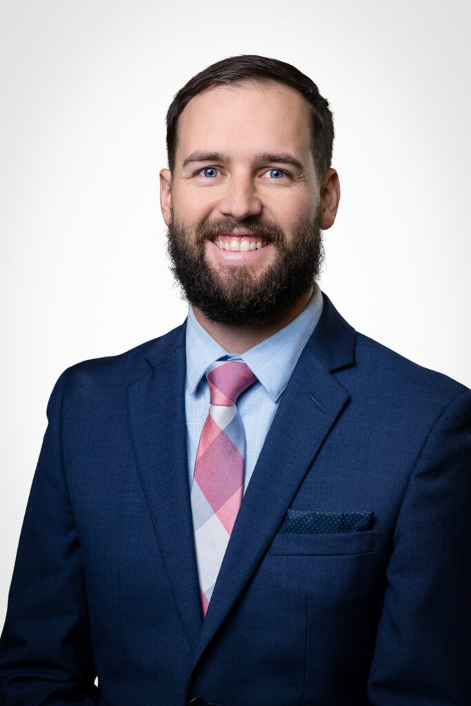 Businessman with beard wearing blue suit.