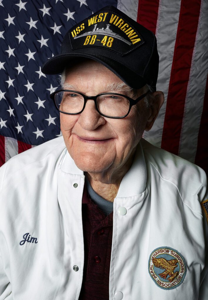 Veteran smiling in front of American flag