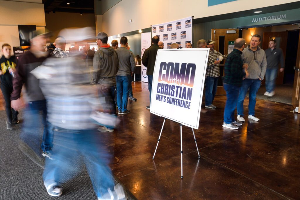 Men walk through the hallways at the COMO Christian Men's Conference in Columbia, MO.