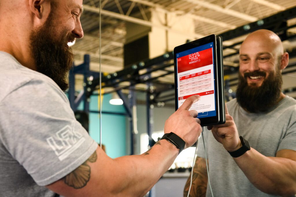 Instructor touches ipad screen for life fitness