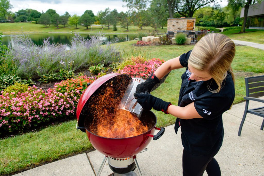weber grill instructor dumps charcoal into grill