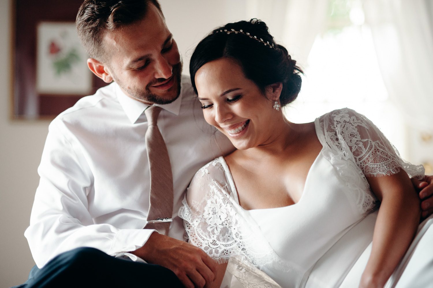 bride and groom laugh together on wedding day