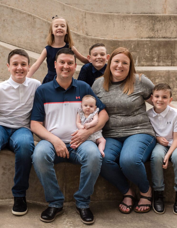 family sitting on concrete steps