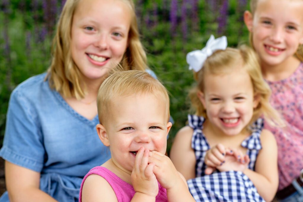 Small children look into camera lens