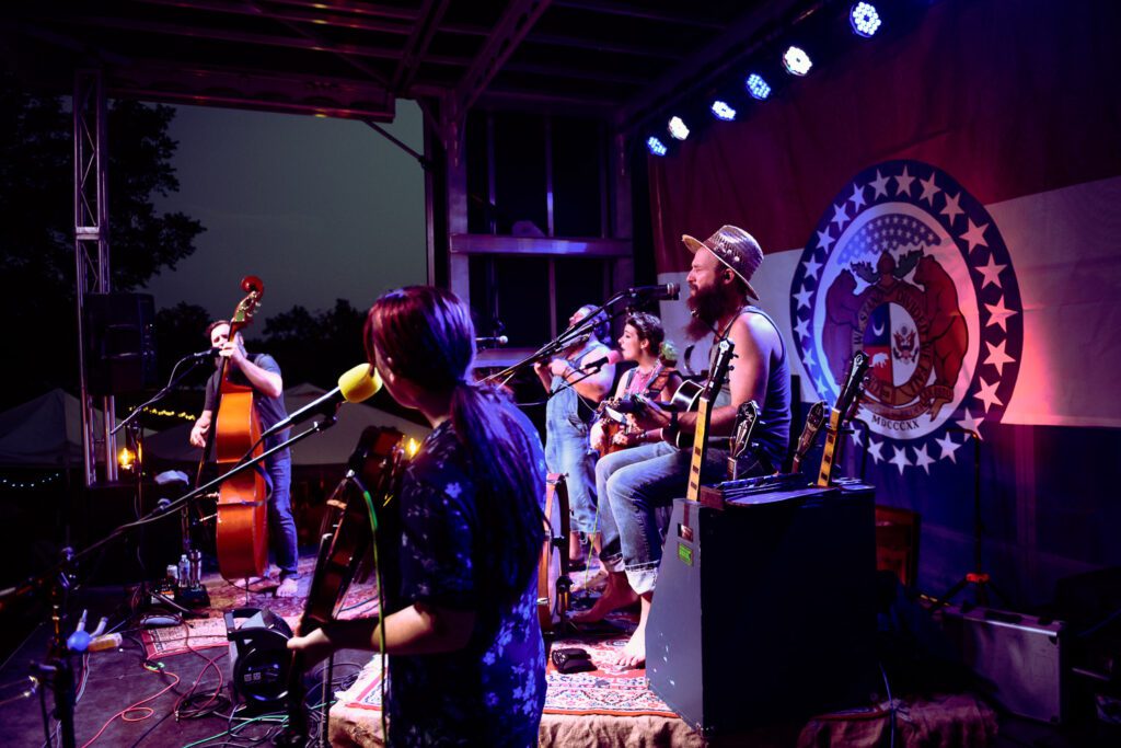 Pat Kay sings with the Burney Sisters on stage