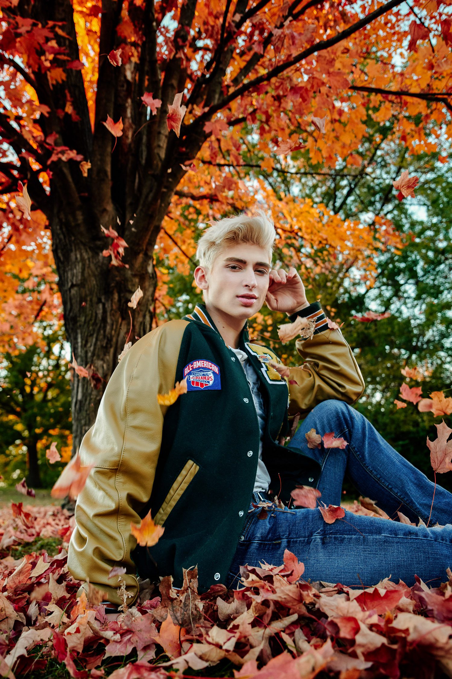 Senior Zachary Willmore sitting in fall leaves Columbia Missouri.