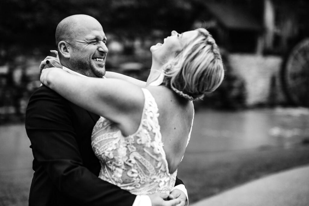 Bride and groom hugging and laughing black and white