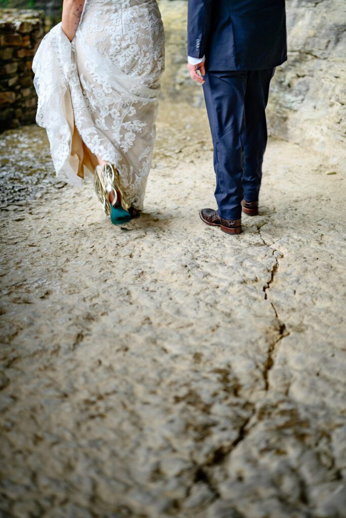 bride and groom walk away in rain