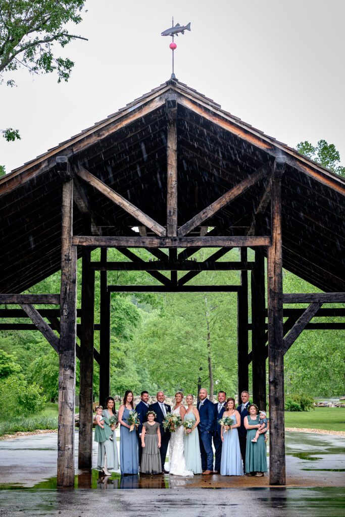 Wedding Party stands under lodge at Dogwood Canyon
