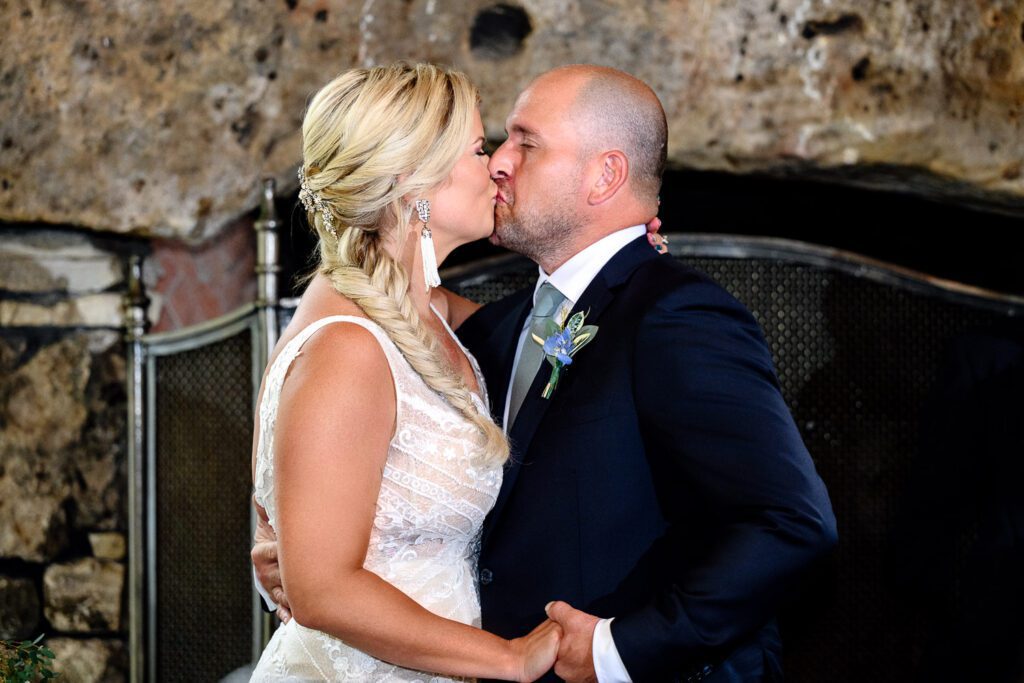 First kiss during wedding ceremony at Dogwood Canyon