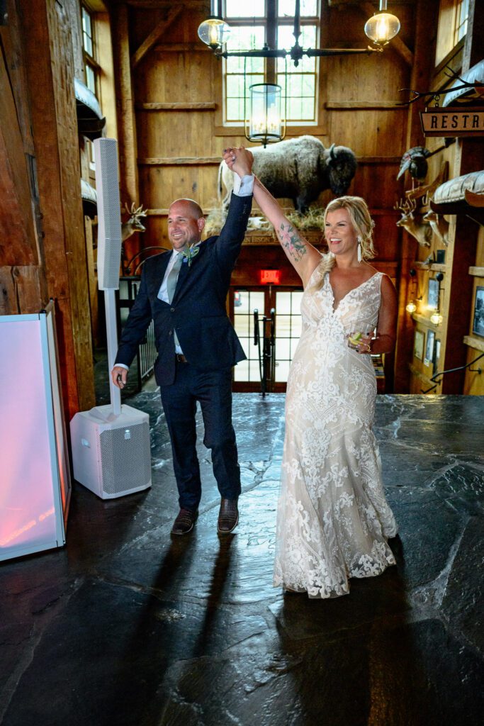 Bride and Groom hold hands up as they are announced at Dogwood Canyon