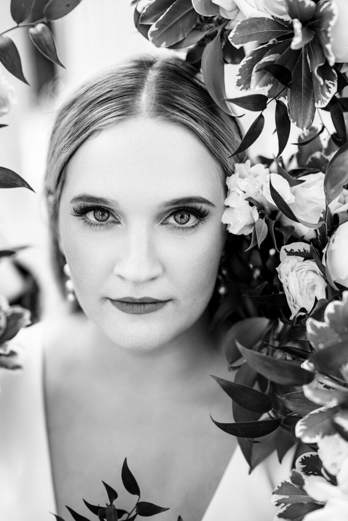 Bride's face surrounded by her wedding flowers