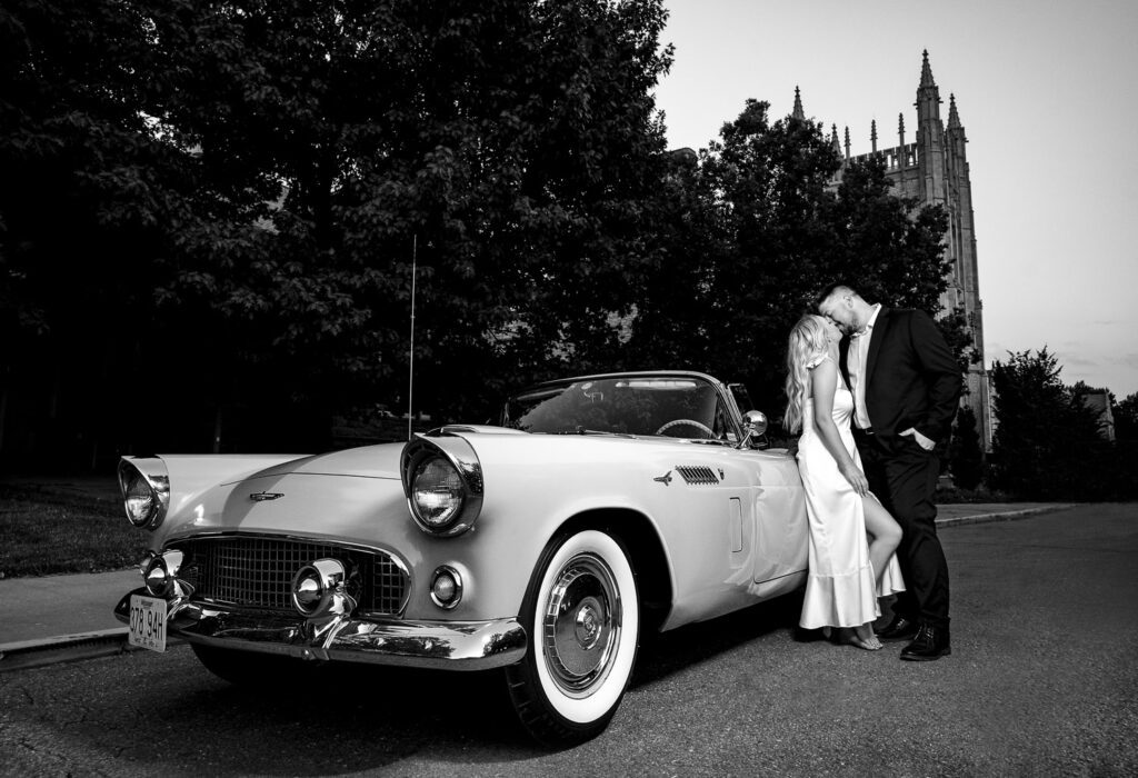 Engaged couple lean on 1956 Thunderbird in front of Memorial Union on the Mizzou Campus.