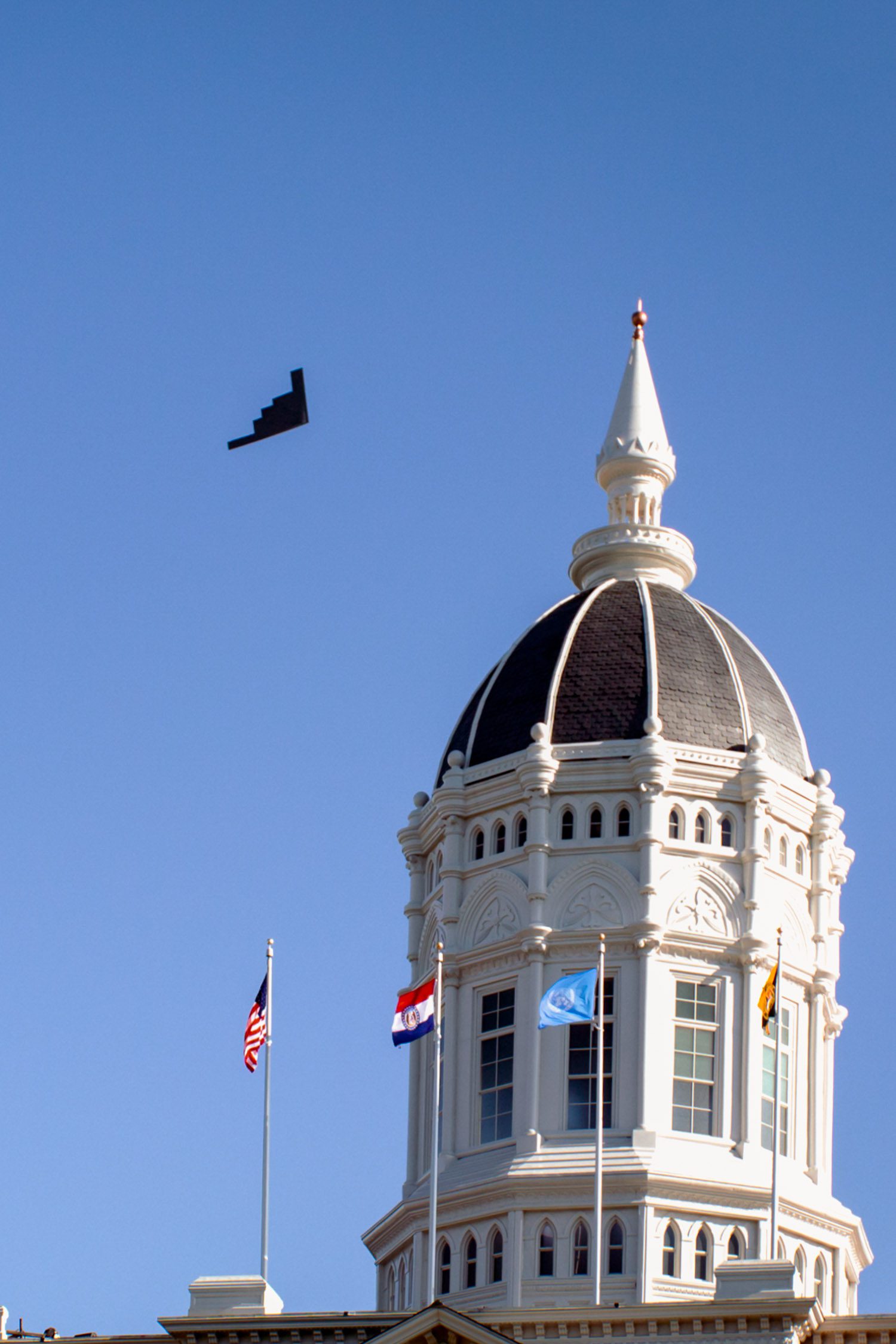 A B2 Stealth Bomber from Whiteman Air Force Base flys past the dome of Jesse Hall at Mizzou.