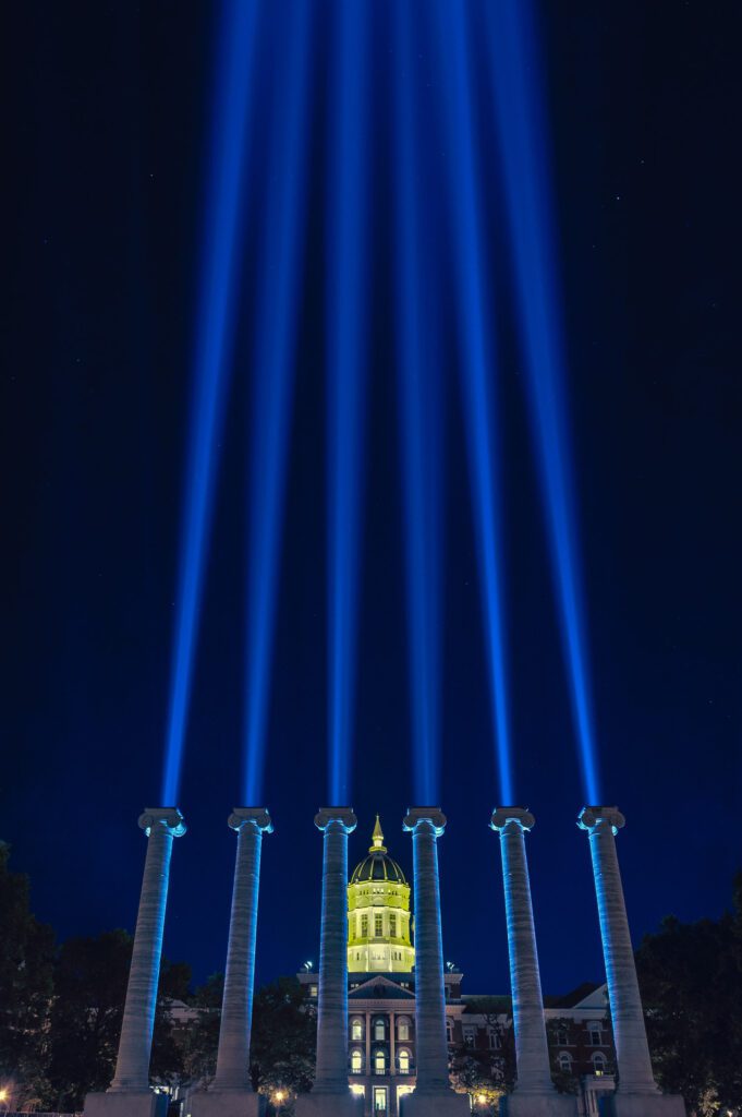 6 Pillars of Light shoot into the sky from behind the Mizzou Columns on the 175th Anniversary of the University of Missouri. 