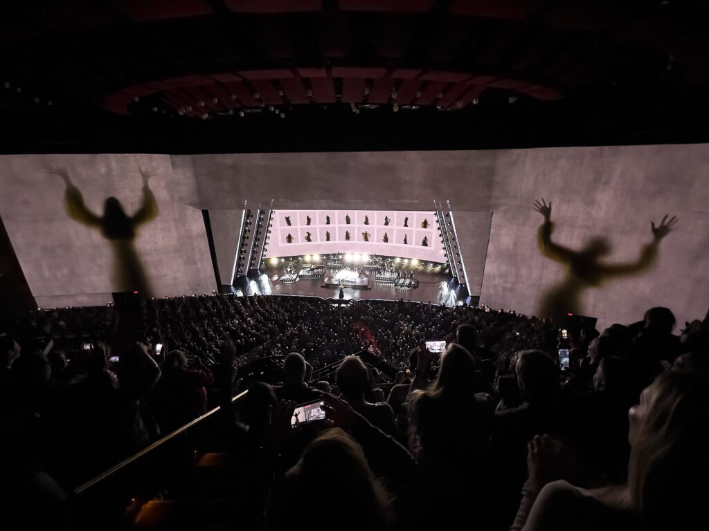 Shadows of Adele are projected on walls of Las Vegas Colosseum.