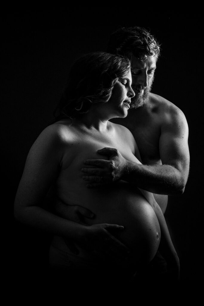 Expecting couple pose nude during Maternity Session
